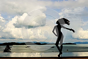 Silouette of Slim Shape Woman Fashion Post on Swimming Pool reflection