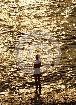 Silouette of young girl in front of sea