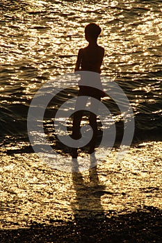 Silouette of young girl in front of sea photo