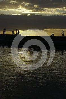 Silouhette on a pier in sunset