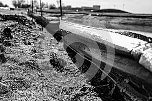 silt fence at a construction site with exposed dirt piled against the fabric