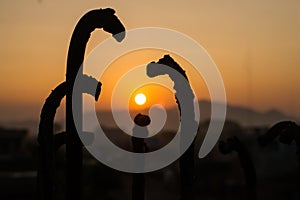 Siluet iron and sunset background