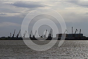 Siluette of the river port under heavy clouds before the rain