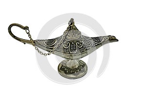 Silver Aladdins lamp on a white background. Ornamental textured old metallic lamp with chain and cap. Antique style