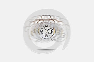 Silver alarm clock alerting on gray background. photo