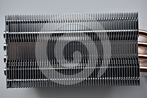 Silver aluminum CPU radiator with copper cooling tubes close-up