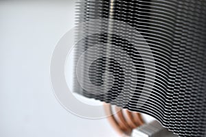 Silver aluminum CPU radiator with copper cooling tubes close-up