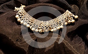 Silver anklet in black background photo