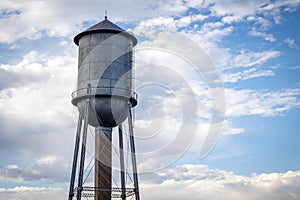 Silver Antique Water Tower Against a Partially Cloudy Sky