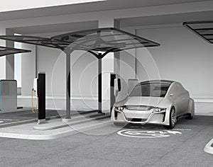 Silver autonomous car in electric vehicle charging station