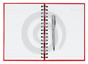 Silver ball point pen on red notebook