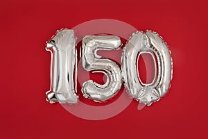 Silver 150 balloons on wine red matt background