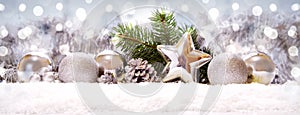 Silver balls and Christmas decoration on snow .