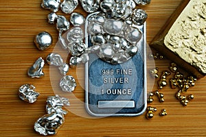 Silver bar silver nuggets and gold bar precious metals money investment economy assets treasure