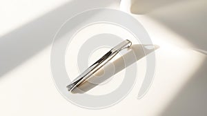 Silver barrette is sitting on a white surface