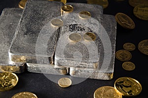 Silver Bars with Gold Coins on Black Background