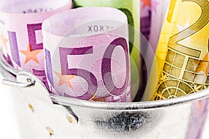 Silver basket full of big euro banknotes