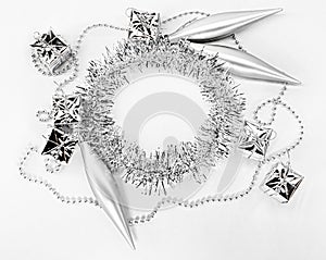 Silver beads, chain of balls, toys, little gifts, round circle of tinsel. New year decorations of on a white background. Christmas