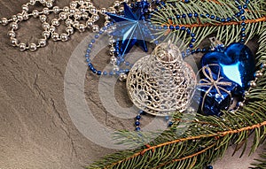 Silver bell with blue decoration and coniferous branch