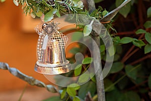 A silver bell on the Christmas tree.