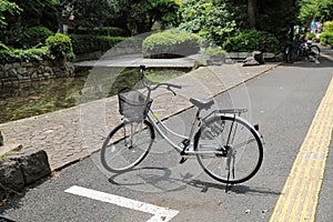 Silver bicycles parked on the sidewalk