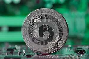 Silver Bitcoin on Blurry Green Background