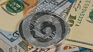 Silver Bitcoin Coin, BTC and Bills of Dollars are Rotating