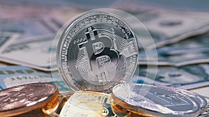 Silver Bitcoin Coin, BTC and Bills of Dollars are Rotating