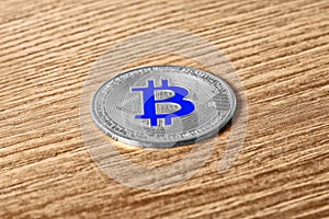 Silver bitcoin on a wooden table