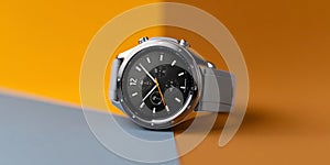 A silver and black wristwatch with a yellow second hand on top of two colored surfaces