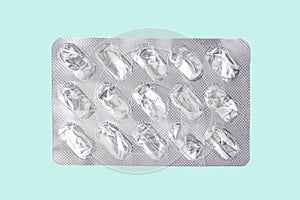 silver blister pack of antibiotic pills on a blue background