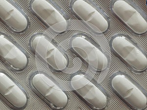 Silver blister with pills for illness and pain treatment. Medical drug package for tablet: vitamin, antibiotic, aspirin, tablets,