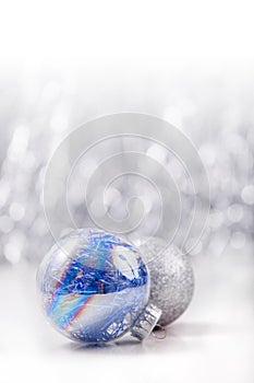 Silver and Blue Christmas ornaments balls on glitter bokeh background with space for text. Xmas and Happy New Year