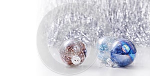 Silver and Blue Christmas ornaments balls on glitter bokeh background with space for text. Xmas and Happy New Year