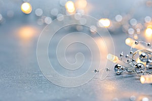 Silver blurred background with christmas lights garland