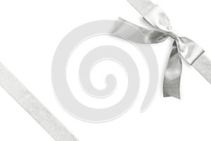 Silver bow satin ribbon band stripe fabric on corner isolated on white background with clipping path for Christmas holiday gift