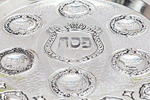 A silver bowl for Passover. Seder Plate. Text - Passover