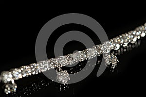 Silver bracelet with crystals on black background