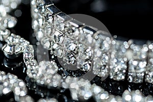 Silver bracelet and diamond necklace close-up on a black background