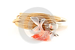 Silver bracelet with leather cord and orange pompon