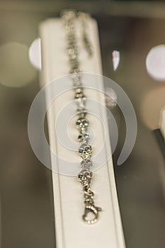 Silver bracelet with skulls on the wind. Selected focus. vertical photo photo