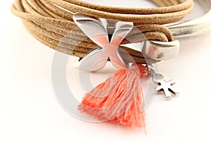 Silver bracelet with leather cord and orange pompon photo