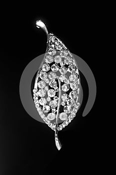 Silver brooch sheet with diamonds isolated on black