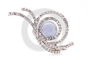 Silver brooch on a white background