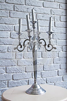 Silver Candelabra, five candles, grey background, on the table