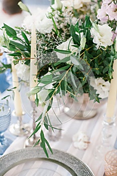 Silver candlestick as element of festive table wedding decorations.