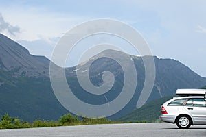 Silver car with carrier in the mountains