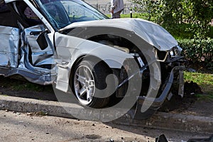 Silver car after a horrible crash accident.
