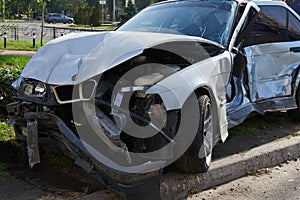 Silver car after a horrible crash accident.
