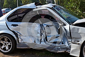 Silver car after a horrible crash accident. Side view,